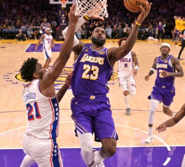 Los Angeles Lakers forward LeBron James #23 drives past Philadelphia 76ers center Joel Embiid #21 at Crypto.com Arena.