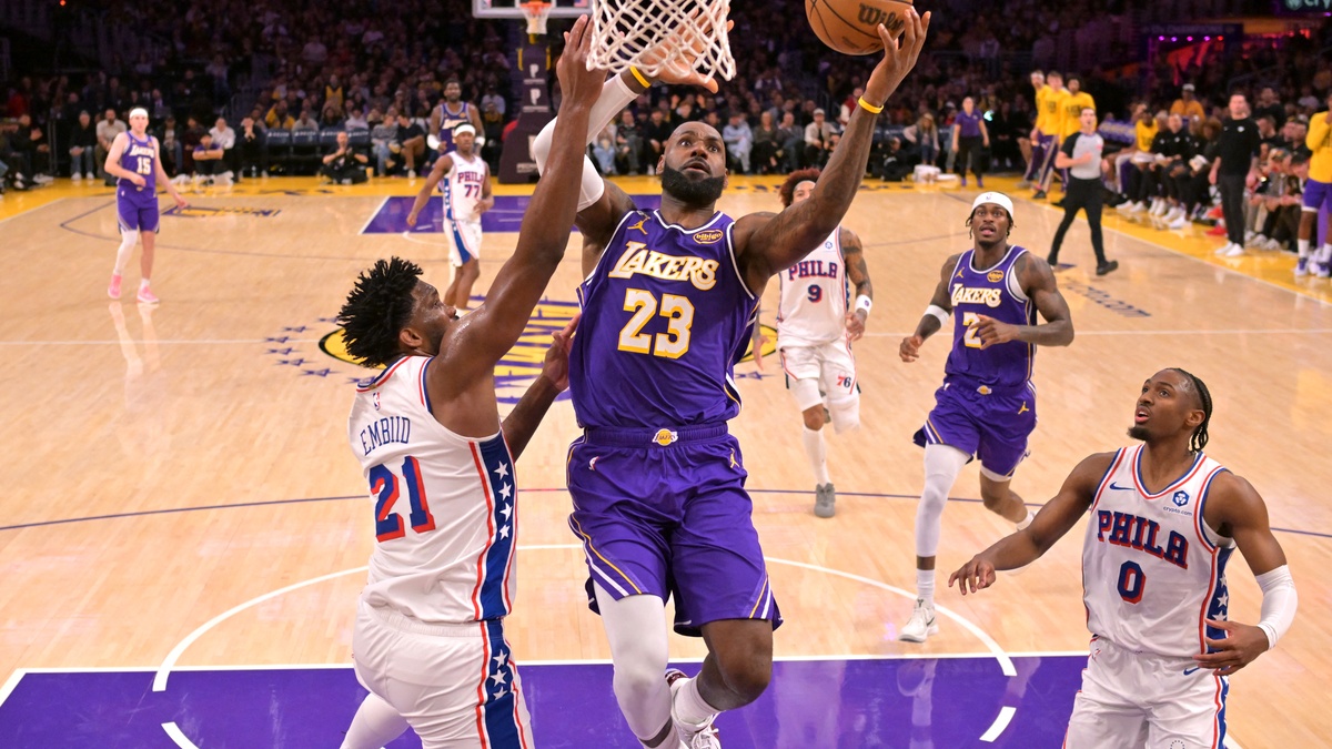 Los Angeles Lakers forward LeBron James #23 drives past Philadelphia 76ers center Joel Embiid #21 at Crypto.com Arena.
