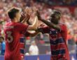 FC Dallas striker Logan Farrington high fives teammate Shaquell Moore after scoring against the Portland Timbers.