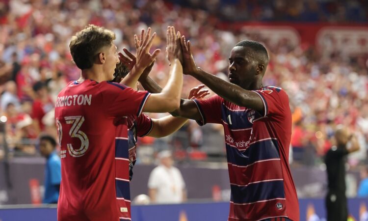FC Dallas striker Logan Farrington high fives teammate Shaquell Moore after scoring against the Portland Timbers.