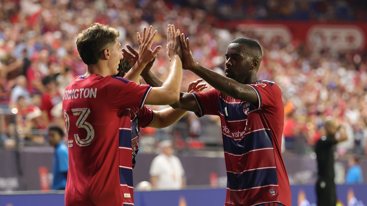 FC Dallas striker Logan Farrington high fives teammate Shaquell Moore after scoring against the Portland Timbers.