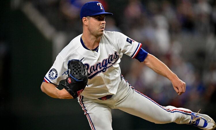Texas Rangers starting pitcher MacKenzie Gore follows through on a pitch with his back leg kicked out behind him.