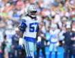 Dallas Cowboys linebacker Malachi Lawrence stands on the field in his helmet and uniform during a game against Seattle.