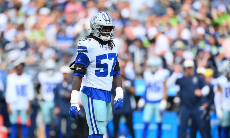 Dallas Cowboys linebacker Malachi Lawrence stands on the field in his helmet and uniform during a game against Seattle.