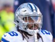 Cowboys safety Malik Hooker kneels in his warmup stretch, helmet on, before kickoff against the 49ers.