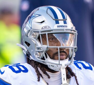Cowboys safety Malik Hooker kneels in his warmup stretch, helmet on, before kickoff against the 49ers.