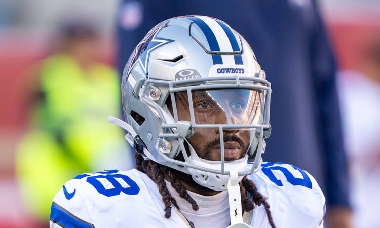 Cowboys safety Malik Hooker kneels in his warmup stretch, helmet on, before kickoff against the 49ers.