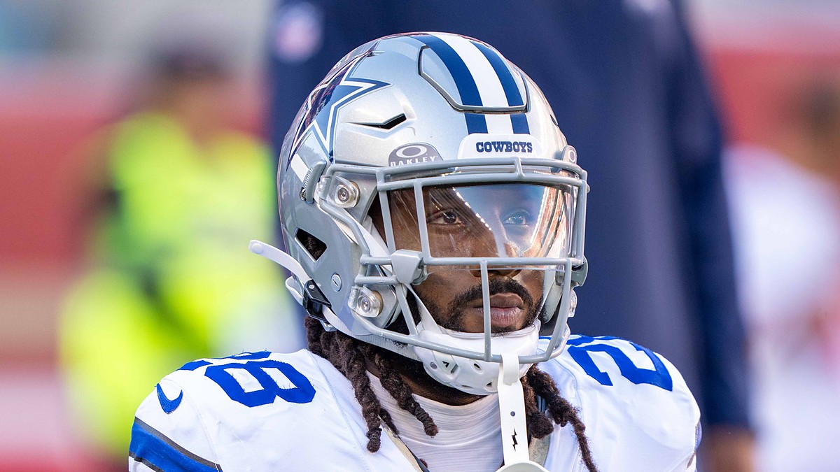 Cowboys safety Malik Hooker kneels in his warmup stretch, helmet on, before kickoff against the 49ers.