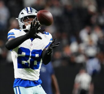 Dallas Cowboys safety Malik Hooker catches a ball during pregame warmups at Allegiant Stadium.