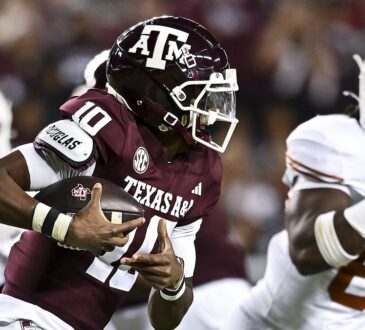 Texas A&M Aggies quarterback Marcel Reed tucks the ball and runs against the Texas Longhorns at Kyle Field.