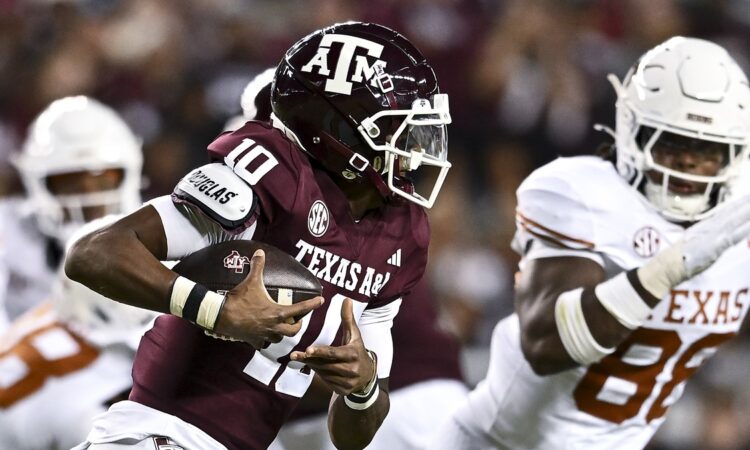 Texas A&M Aggies quarterback Marcel Reed tucks the ball and runs against the Texas Longhorns at Kyle Field.
