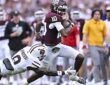 Texas A&M Aggies quarterback Marcel Reed pulls away as a diving Missouri State defender reaches for him.
