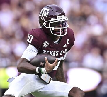 xas A&M Aggies quarterback Marcel Reed, No. 10, tucks the ball and cuts upfield.