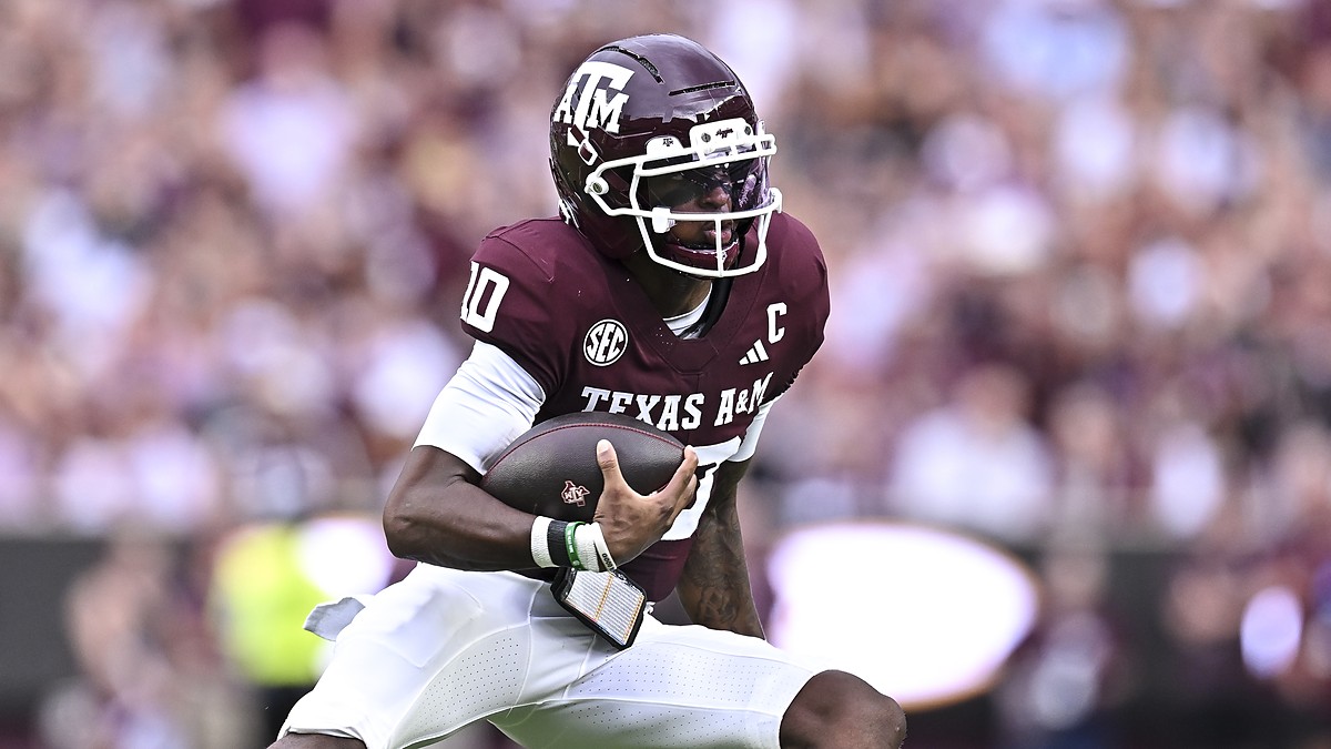 xas A&M Aggies quarterback Marcel Reed, No. 10, tucks the ball and cuts upfield.