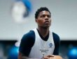 Dallas Mavericks guard Marcus Sasser looks up toward the basket in a white Mavericks practice pinny.
