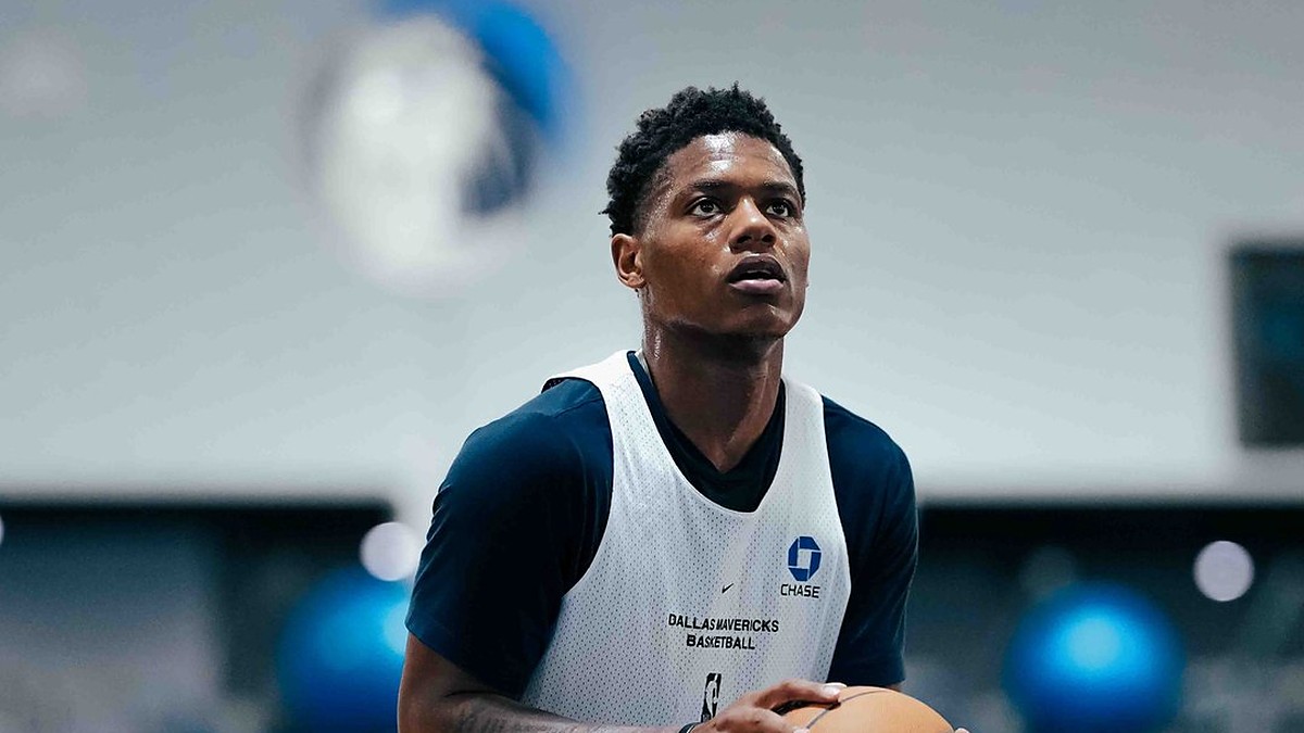 Dallas Mavericks guard Marcus Sasser looks up toward the basket in a white Mavericks practice pinny.