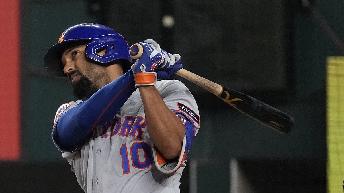 New York Mets second baseman Marcus Semien follows through on a swing as the Rangers catcher looks on.