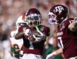 Texas A&M wide receiver Mario Craver, No. 1, holds the ball out and celebrates alongside tight end Theo Melin Ohrstrom, No. 17.