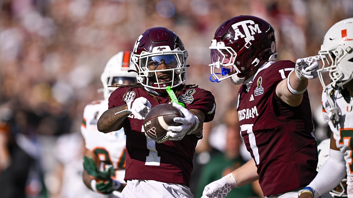 Texas A&M wide receiver Mario Craver, No. 1, holds the ball out and celebrates alongside tight end Theo Melin Ohrstrom, No. 17.