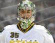 Dallas Stars goaltender Marty Turco looks on in a painted mask and white road jersey at Pepsi Center.