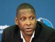 Dallas Mavericks president of basketball operations Masai Ujiri speaks at a press conference in a dark blazer.