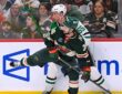 Minnesota Wild forward Mats Zuccarello and Dallas Stars defenseman Thomas Harley collide along the boards.