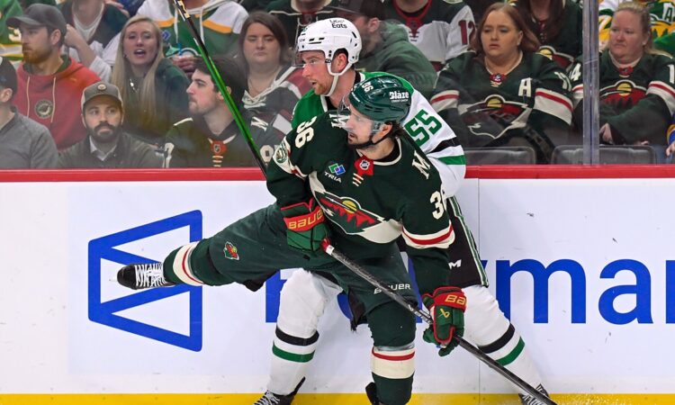 Minnesota Wild forward Mats Zuccarello and Dallas Stars defenseman Thomas Harley collide along the boards.