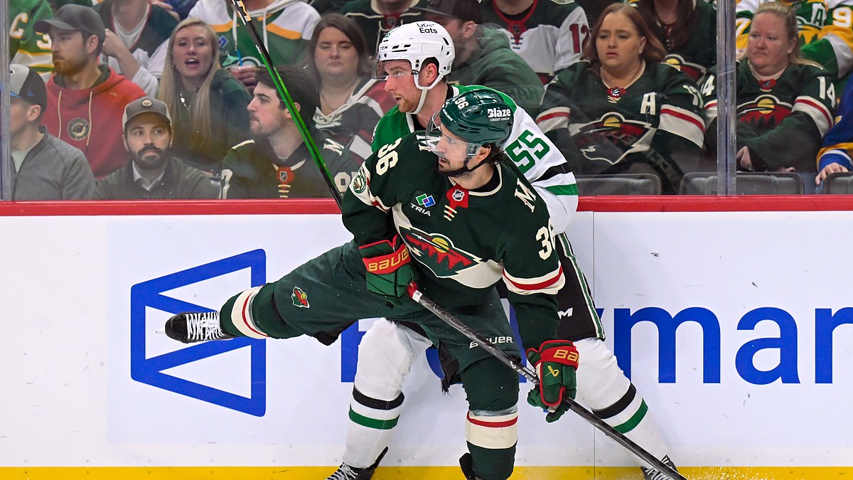 Minnesota Wild forward Mats Zuccarello and Dallas Stars defenseman Thomas Harley collide along the boards.