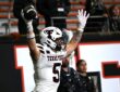 Texas Tech tight end Matt Ludwig raises the football overhead after scoring a touchdown against Oregon State.