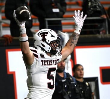 Texas Tech tight end Matt Ludwig raises the football overhead after scoring a touchdown against Oregon State.