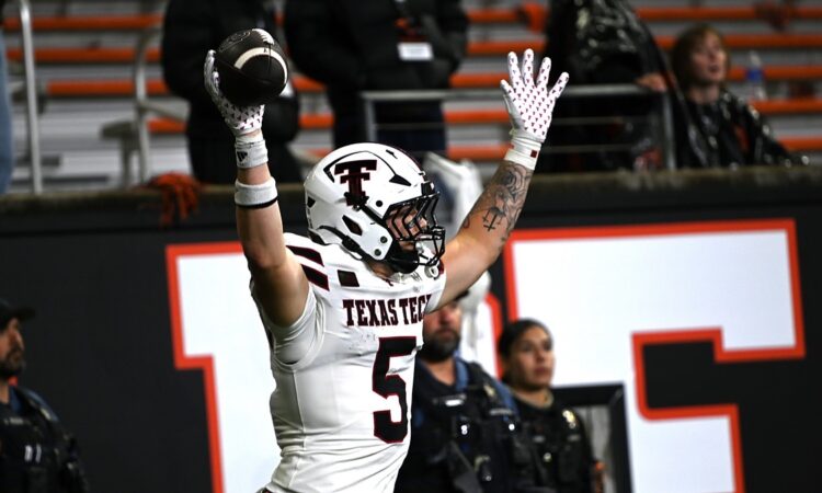 Texas Tech tight end Matt Ludwig raises the football overhead after scoring a touchdown against Oregon State.