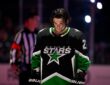 Dallas Stars center Mavrik Bourque, No. 22, stands with his head down on the ice before a playoff game.