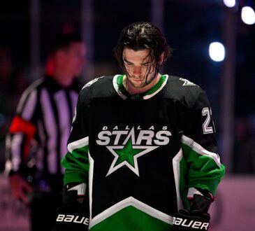 Dallas Stars center Mavrik Bourque, No. 22, stands with his head down on the ice before a playoff game.