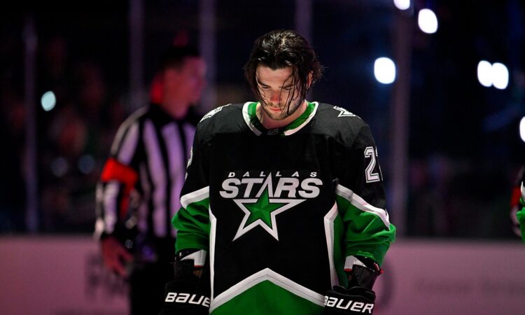 Dallas Stars center Mavrik Bourque, No. 22, stands with his head down on the ice before a playoff game.