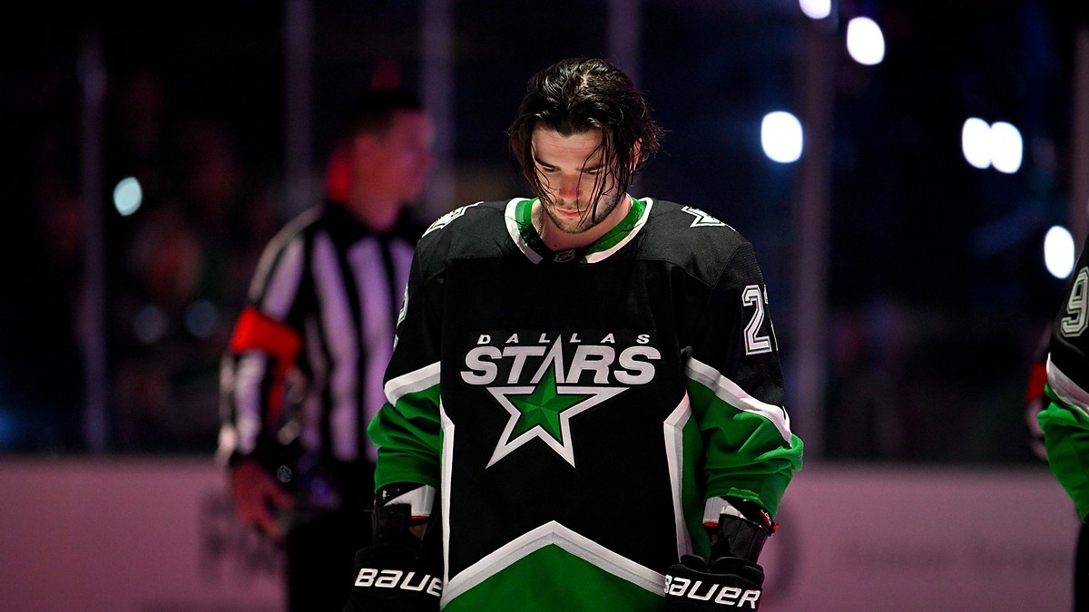 Dallas Stars center Mavrik Bourque, No. 22, stands with his head down on the ice before a playoff game.