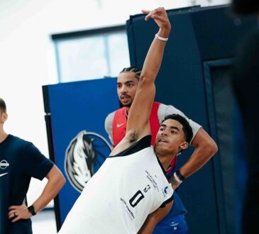 Dallas Mavericks guard Max Christie holds his follow-through after a shot during a practice drill.