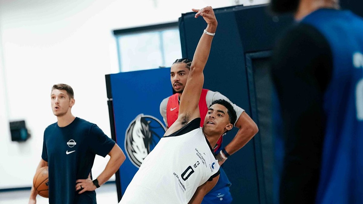 Dallas Mavericks guard Max Christie holds his follow-through after a shot during a practice drill.