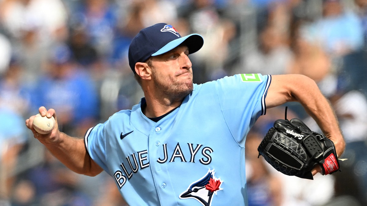 Toronto Blue Jays starting pitcher Maxwell Scherzer winds up to deliver a pitch in a light blue Blue Jays jersey.