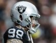 Las Vegas Raiders defensive end Maxx Crosby, No. 98, stands in profile in his helmet before a game.