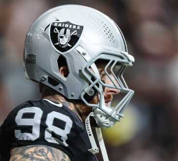Las Vegas Raiders defensive end Maxx Crosby, No. 98, stands in profile in his helmet before a game.