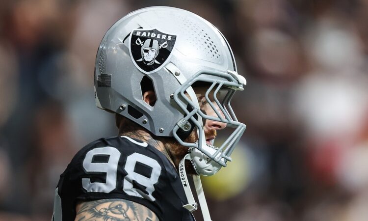 Las Vegas Raiders defensive end Maxx Crosby, No. 98, stands in profile in his helmet before a game.