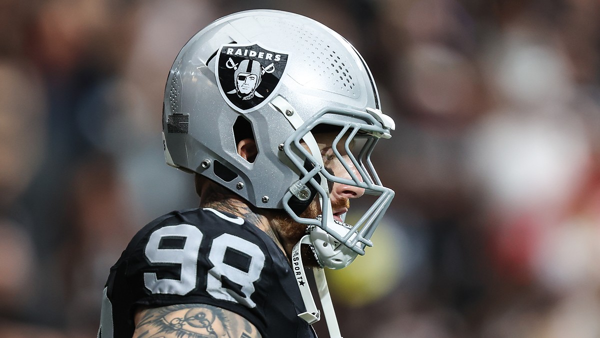 Las Vegas Raiders defensive end Maxx Crosby, No. 98, stands in profile in his helmet before a game.