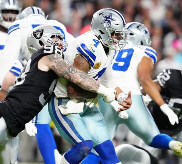 Las Vegas Raiders defensive end Maxx Crosby wraps up Dak Prescott as the ball comes loose behind them.