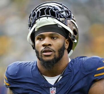 Green Bay Packers defensive end Micah Parsons walks off with his helmet pushed up after a game against Carolina.