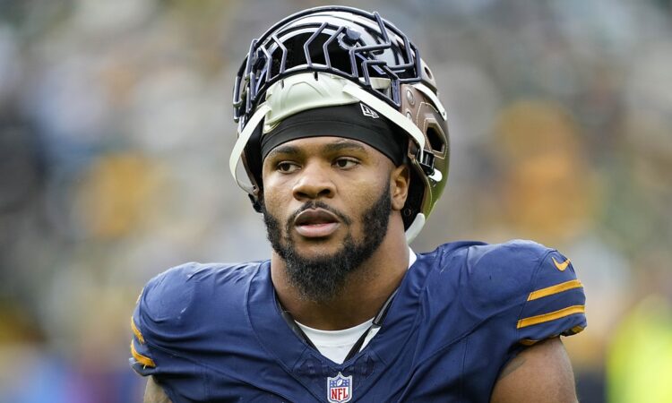 Green Bay Packers defensive end Micah Parsons walks off with his helmet pushed up after a game against Carolina.