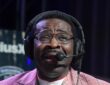Former Dallas Cowboys receiver Michael Irvin speaks into a headset microphone on radio row.