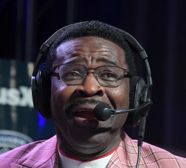 Former Dallas Cowboys receiver Michael Irvin speaks into a headset microphone on radio row.