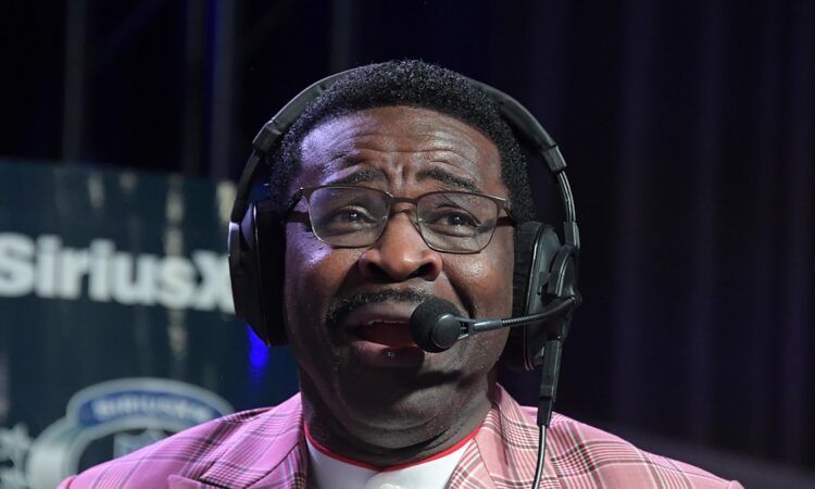 Former Dallas Cowboys receiver Michael Irvin speaks into a headset microphone on radio row.