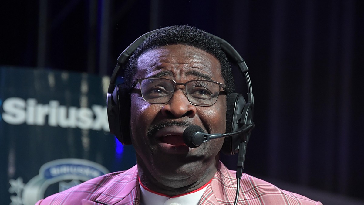 Former Dallas Cowboys receiver Michael Irvin speaks into a headset microphone on radio row.