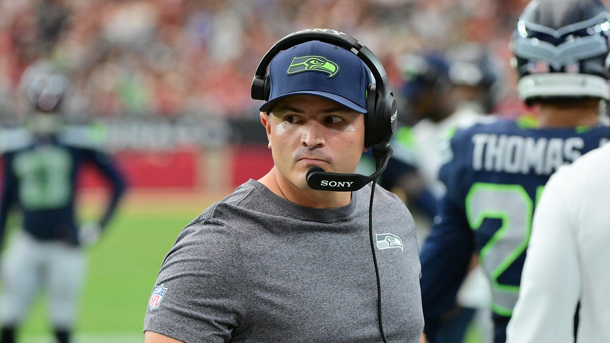 Seattle Seahawks head coach Michael Macdonald glances to his left on the sideline while wearing a headset.